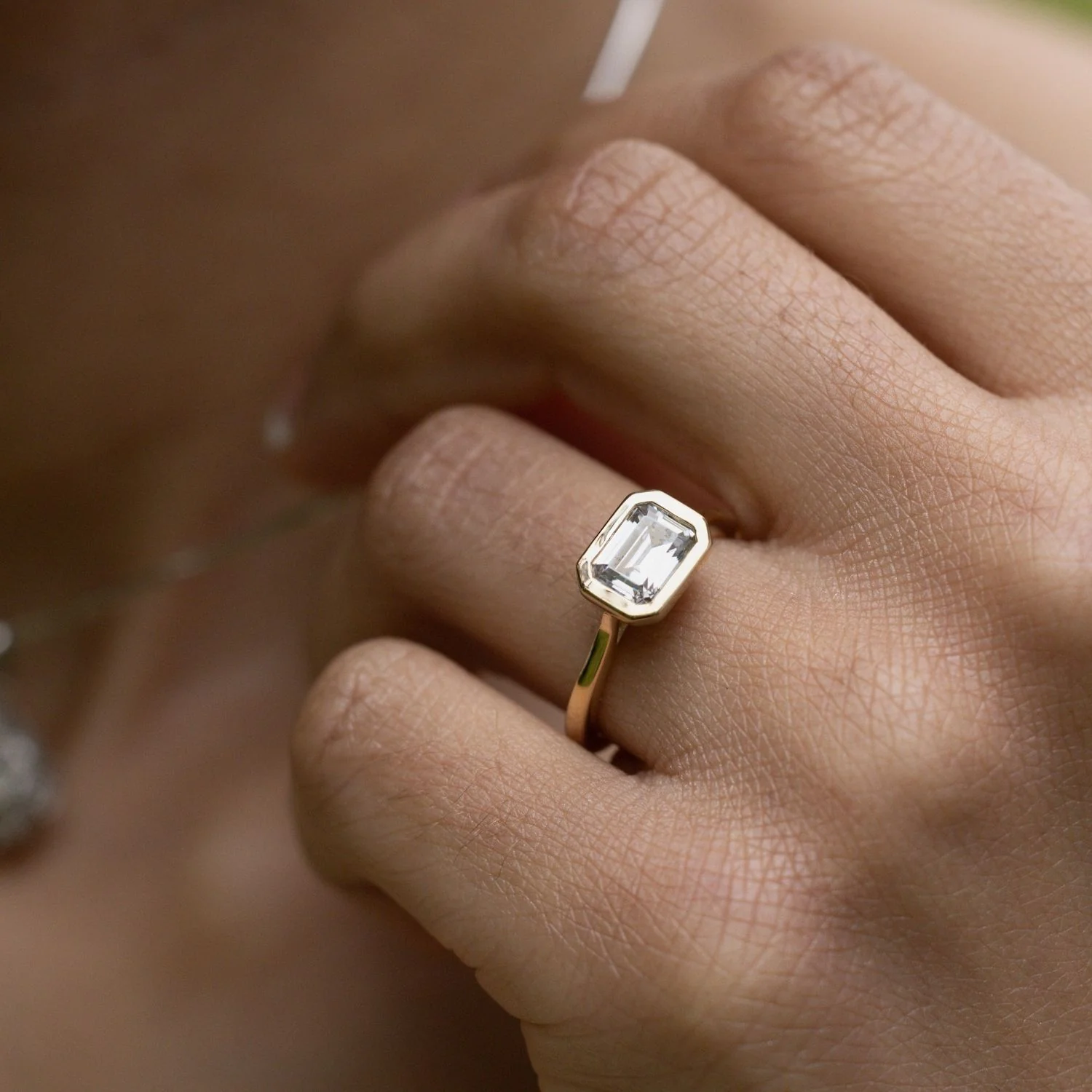 The Adeline - Hidden Halo Emerald Cut Moissanite Engagement Ring with Bezel Setting - Image 10