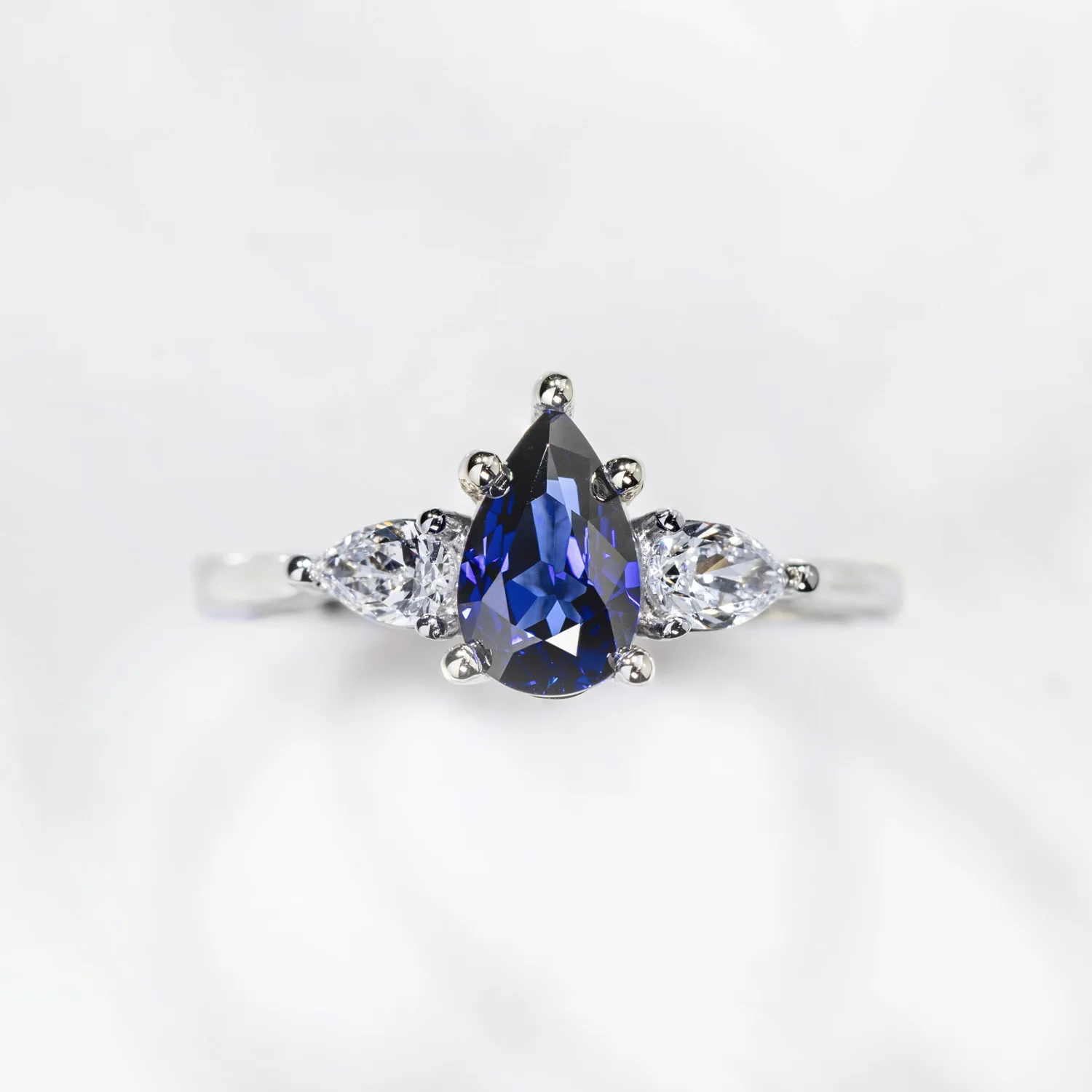 The Diana - Blue Sapphire Pear Cut Three Stone Engagement Ring with Diamond Accents - Image 12