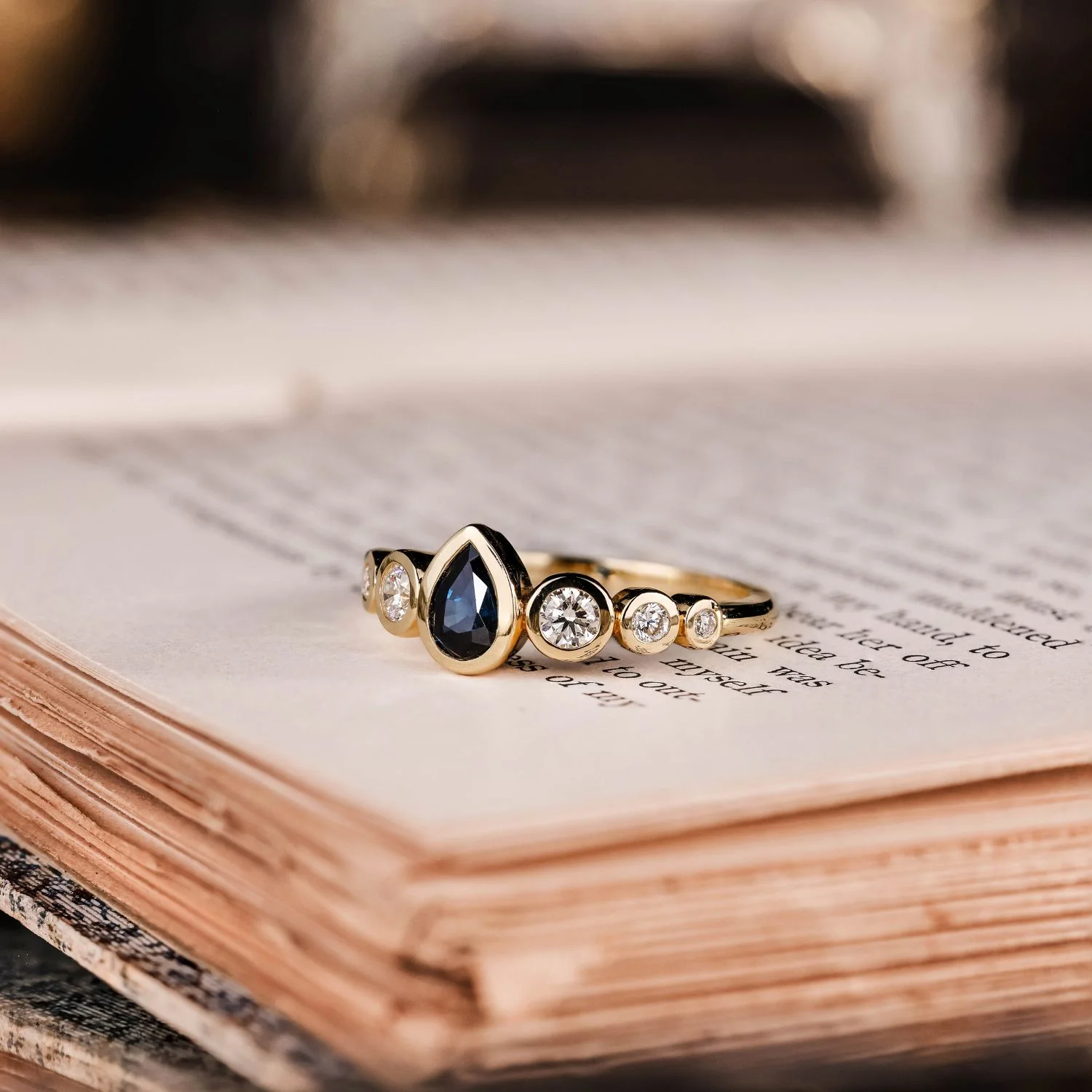 The Lyra - Bezel Set Pear Cut Blue Sapphire Engagement Ring with Diamond Accents - Image 3