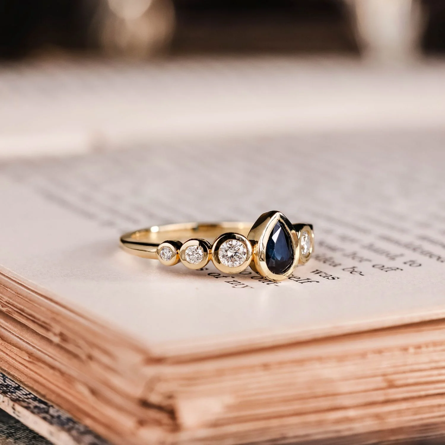 The Lyra - Bezel Set Pear Cut Blue Sapphire Engagement Ring with Diamond Accents - Image 7