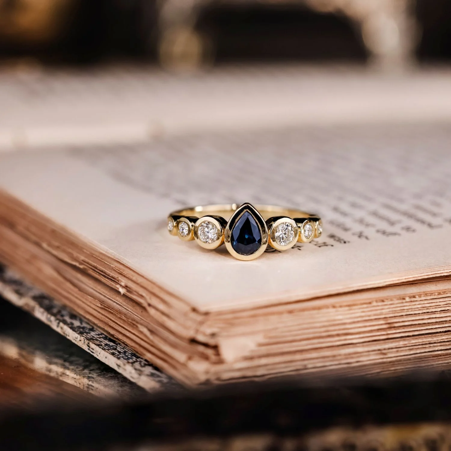 The Lyra - Bezel Set Pear Cut Blue Sapphire Engagement Ring with Diamond Accents - Image 9